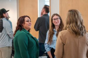 Adult Learners | Pictured: Adult learners at a networking event talking in a university setting